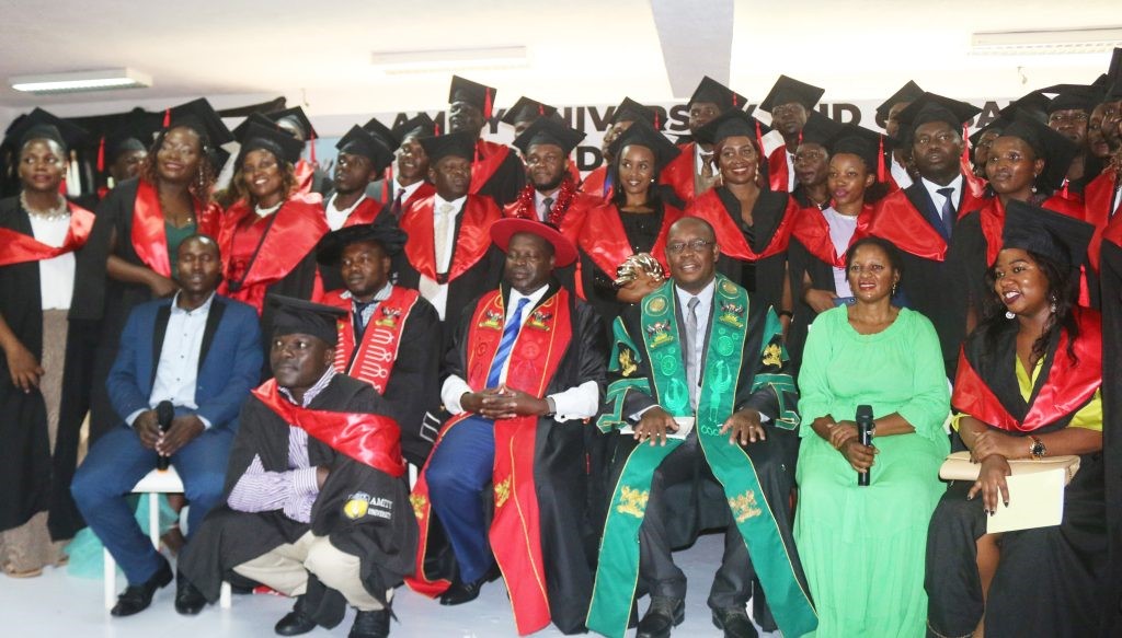 Another section of graduands posing for a group photo with the college management